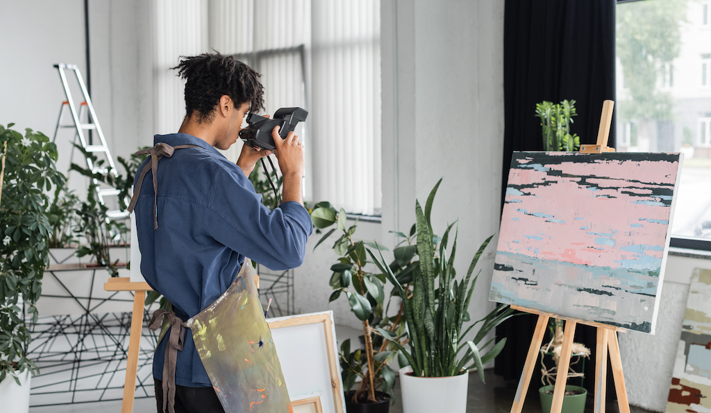 Printing Art Prints: A Step-By-Step Guide 1 Art student photographing his painting to create art prints