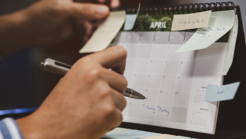 Every Date You Need to Include When Printing a Custom Calendar in Canada 2 Man writing important dates on his business calendar
